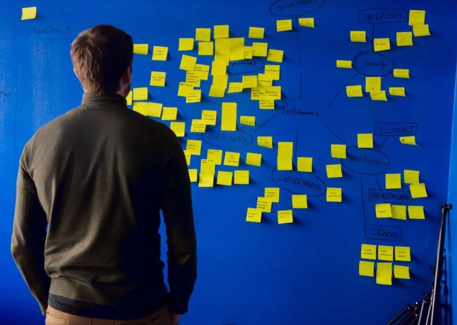 Person planning content on a wall of sticky notes